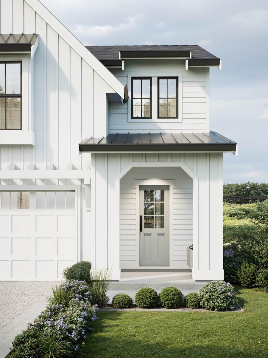 House plan exterior. Two-story Modern Farmhouse with a gabled roof, a covered entry porch, and a garage door visible on the left.