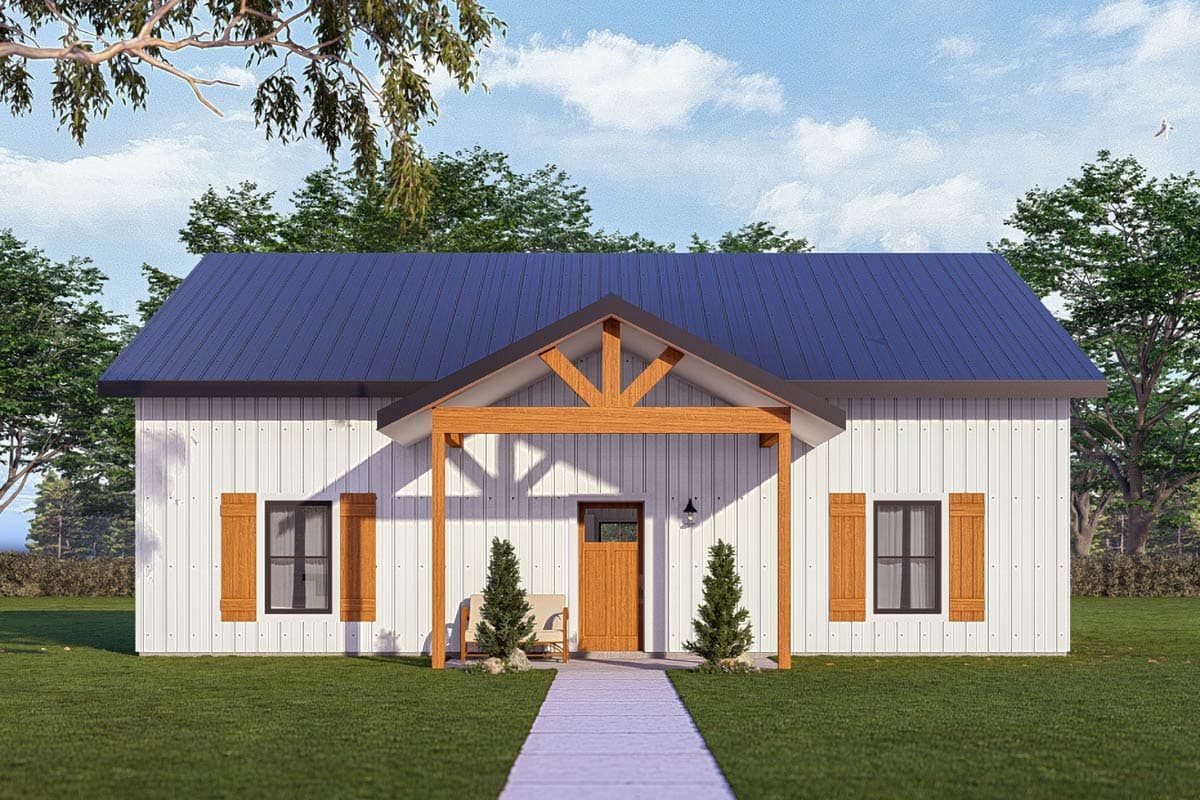A white farmhouse with a blue roof, wooden porch, and shutters. A path leads to the front door, flanked by small trees and a bench. 