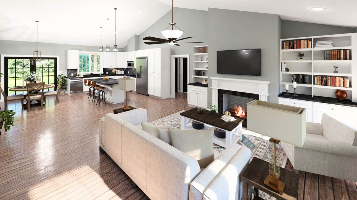 Open concept living area with kitchen island, fireplace, vaulted ceiling, and dining area.