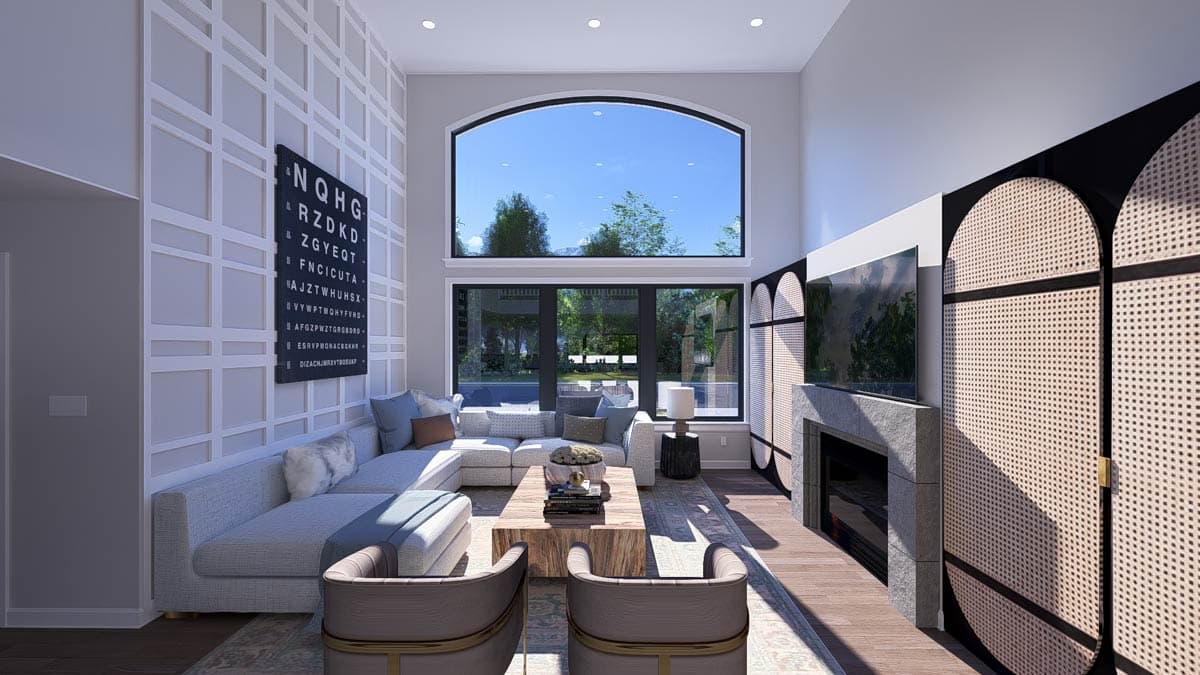 Great room with vaulted ceiling, large arched window, sectional sofa, fireplace, and wall paneling.