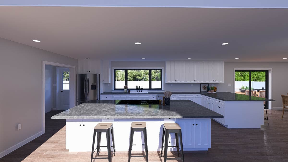 Modern kitchen with large island, white cabinetry, stainless steel appliances, and wide windows overlooking outdoors.