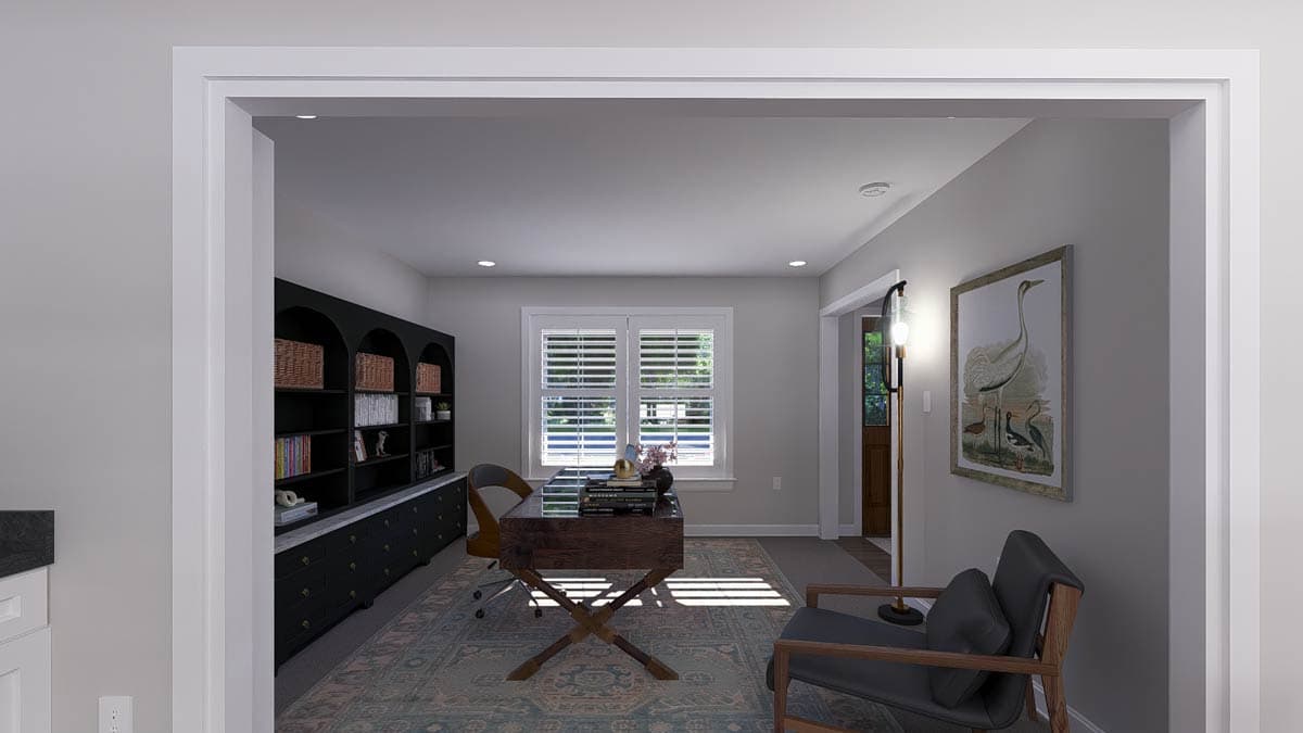 Home office with a large built-in bookshelf, wooden desk, chair, and window with shutters.