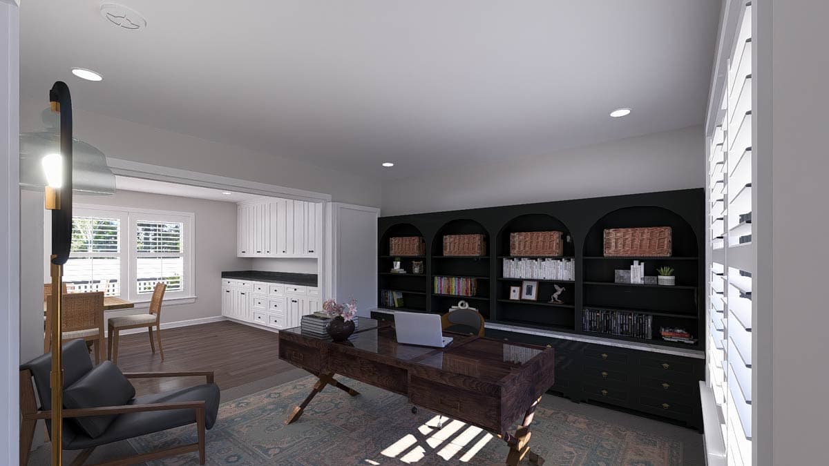 Home office with a desk, built-in shelving, and adjacent dining area with cabinetry.