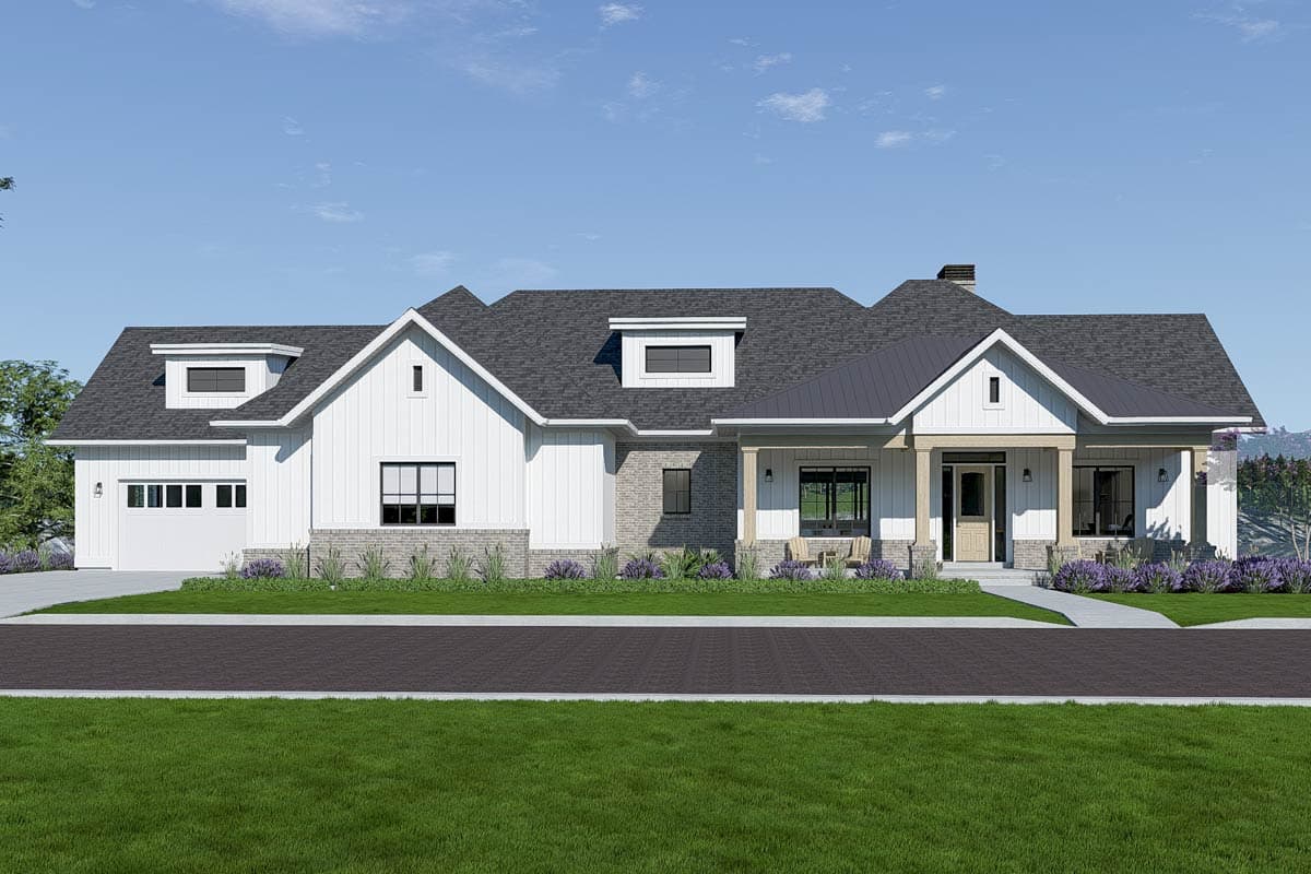 A modern farmhouse with white siding, a dark gray roof, and a front porch. Landscaping includes green grass and purple flowers.