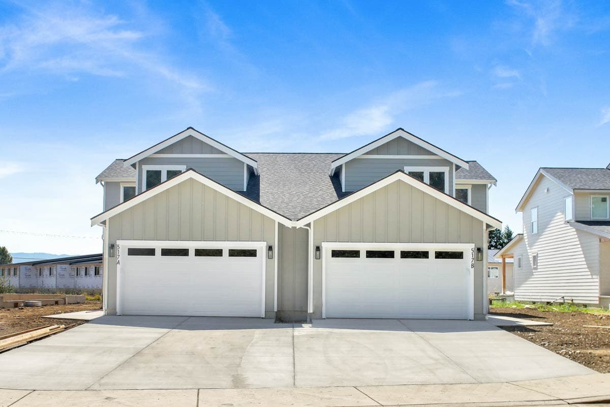 Modern Farmhouse house plan exterior with two stories, gable dormers, and double garage doors.