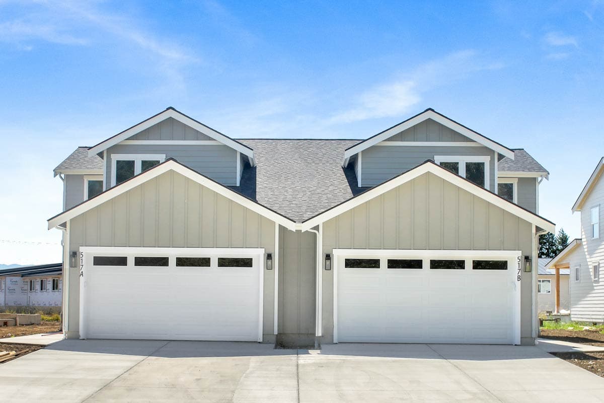 Modern Farmhouse house plan exterior with gable rooflines, two stories, and attached two-car garages.