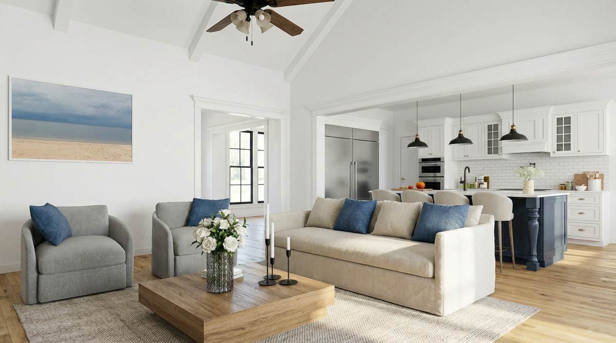 A bright and airy living room, with a beige sofa, two armchairs, and a view into the kitchen area, showing white cabinets and a dark blue island.