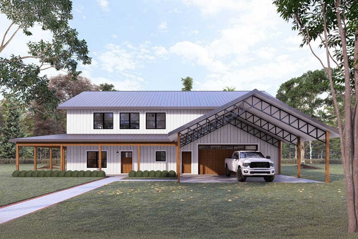 A two-story white farmhouse with a metal roof and a carport with a pickup truck parked underneath. Green grass surrounds the house.