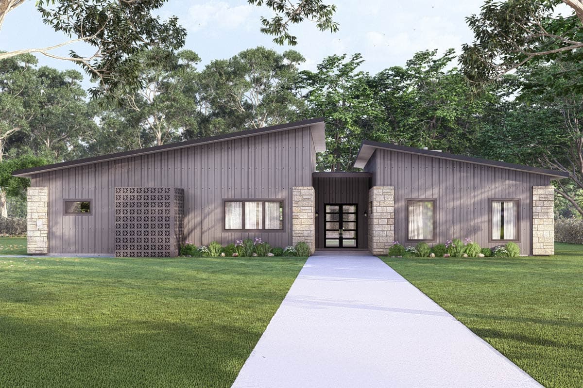 Modern single-story home with a grey exterior, angled roof, and a paved walkway leading to the front door, surrounded by green grass and trees.