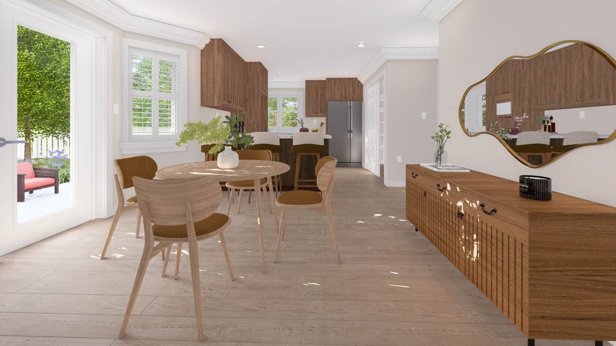 Dining area with round table and chairs, open to kitchen with island and bar stools. French doors open to patio.