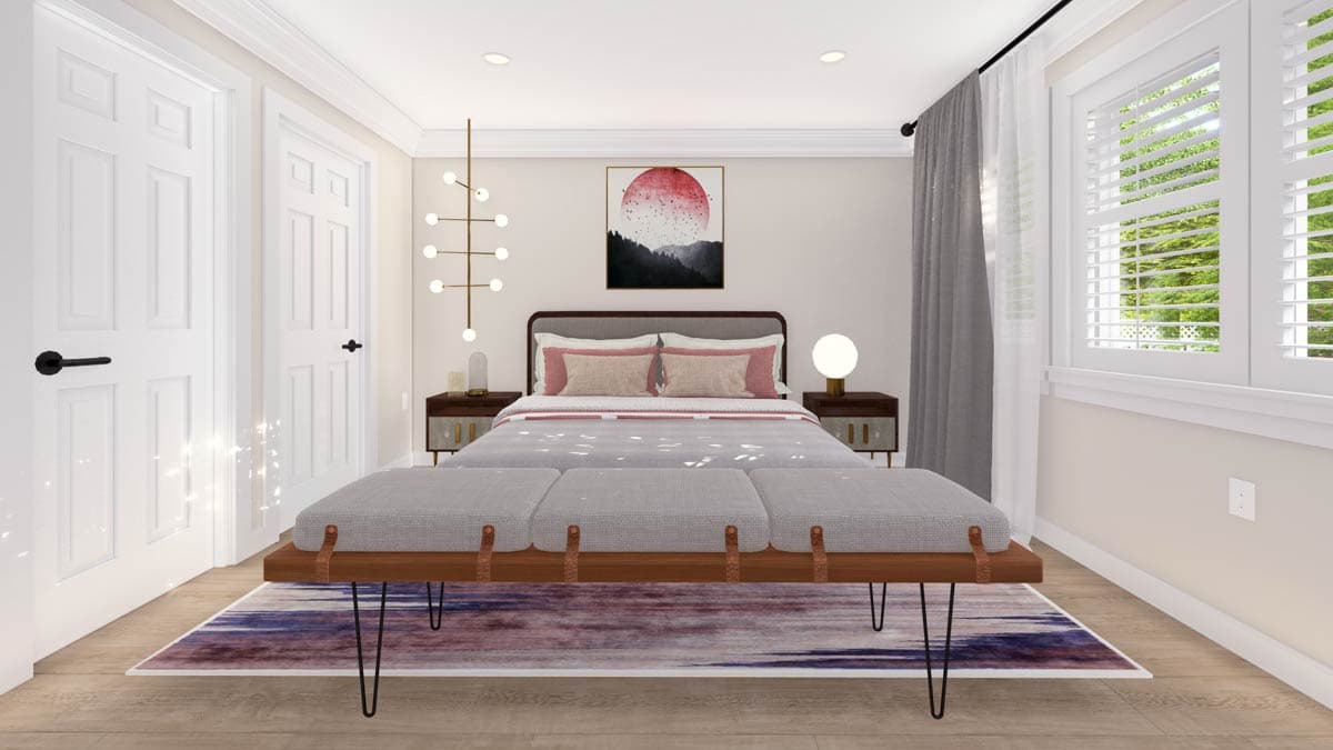 Bedroom with gray upholstered bench, platform bed with pink accent pillows, two nightstands, modern chandelier, and artwork.