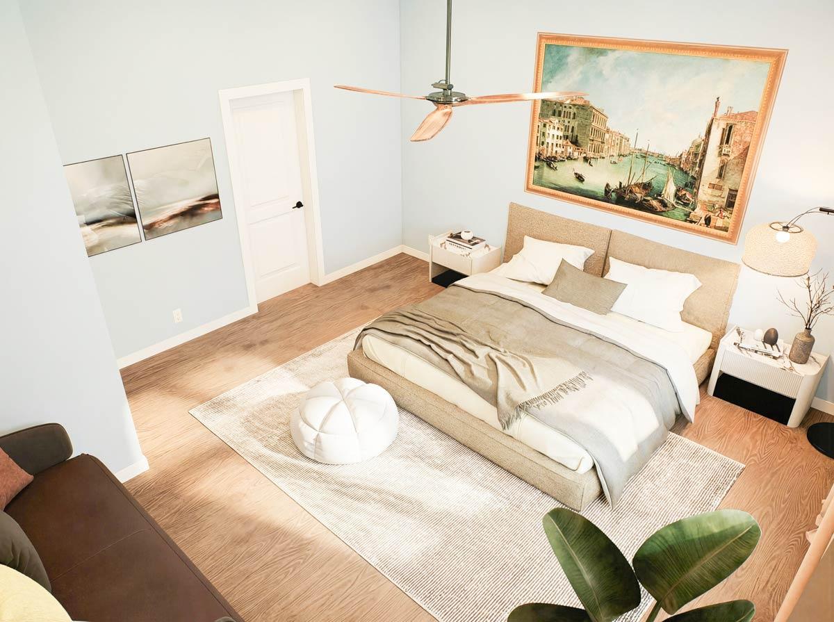 Bedroom with king bed, vaulted ceiling, modern fan, and large Venice canal artwork.