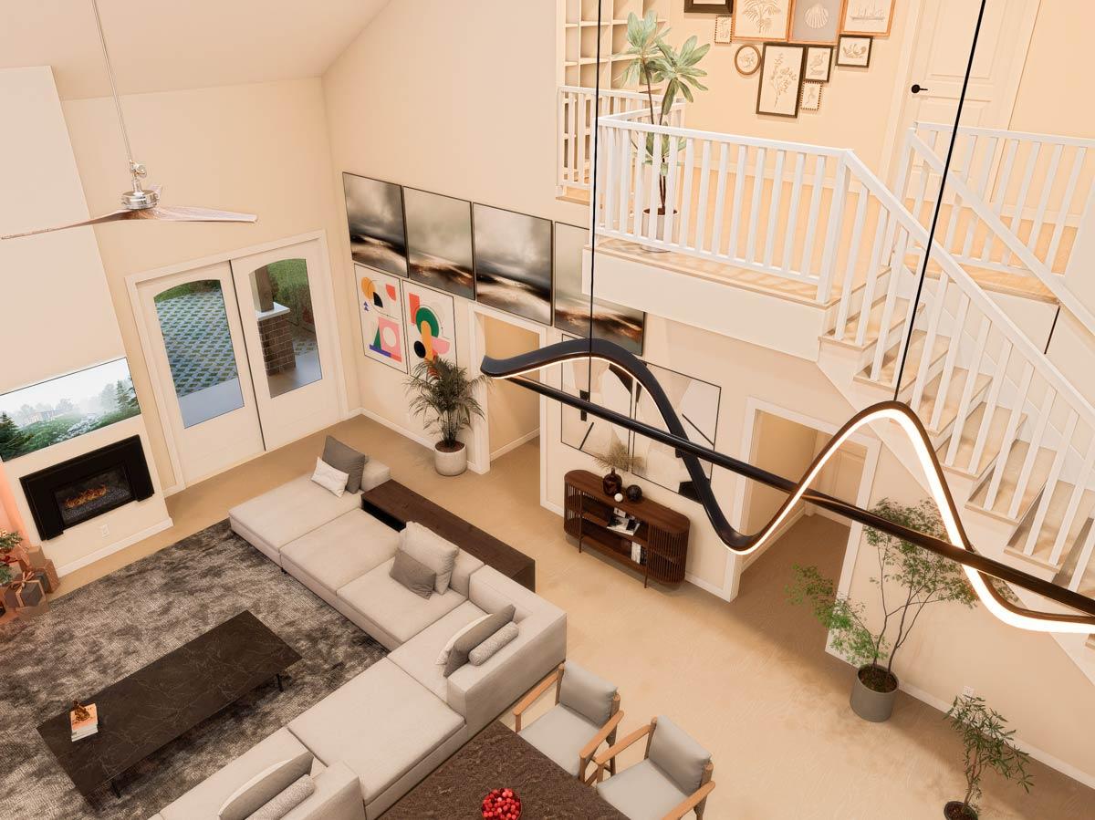 Interior view of an open-concept living area with vaulted ceiling, fireplace, sectional sofa, dining area, and open staircase with railing.