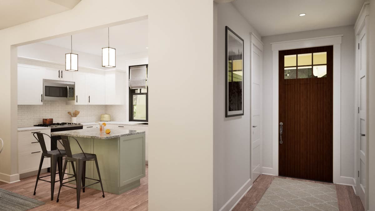 Interior view showing a kitchen with island and a wood front door with glass panes.