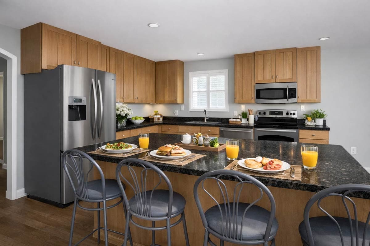 Kitchen with wood cabinetry, granite countertops, stainless steel appliances, and a large island with bar stools.