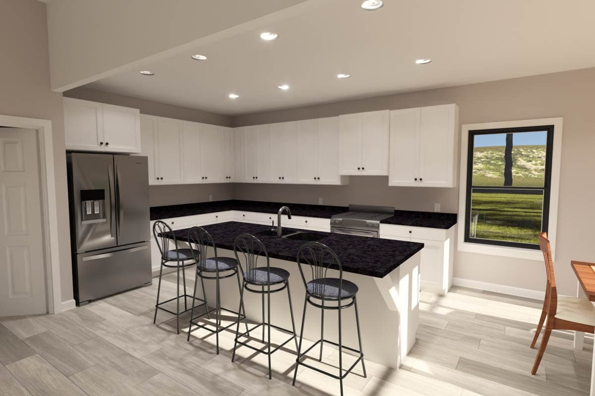 Kitchen with white cabinets, black granite countertops, island with seating, and stainless steel refrigerator.