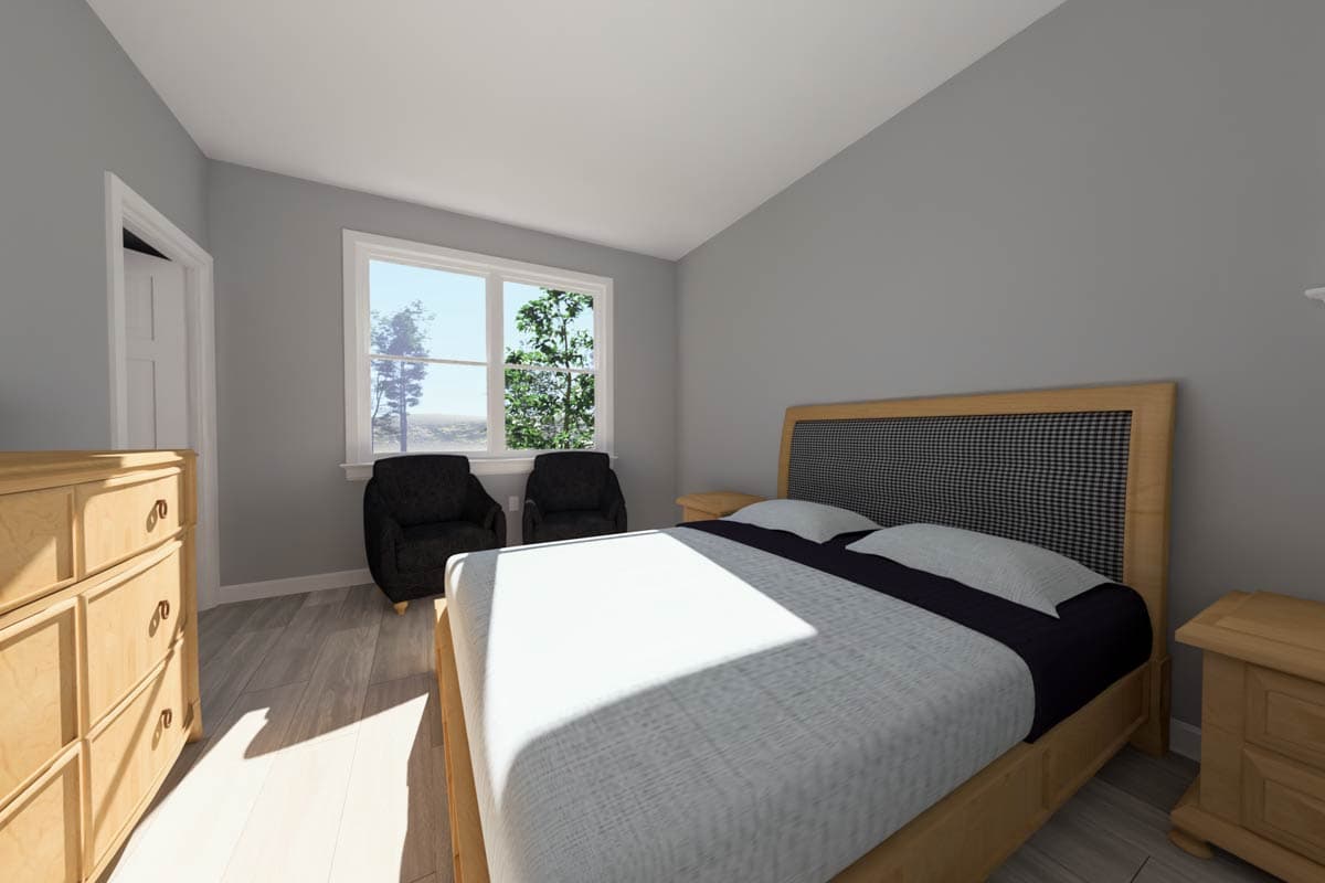 Bedroom with sloped ceiling, wood-framed bed with checkered headboard, dresser, and two armchairs by window.