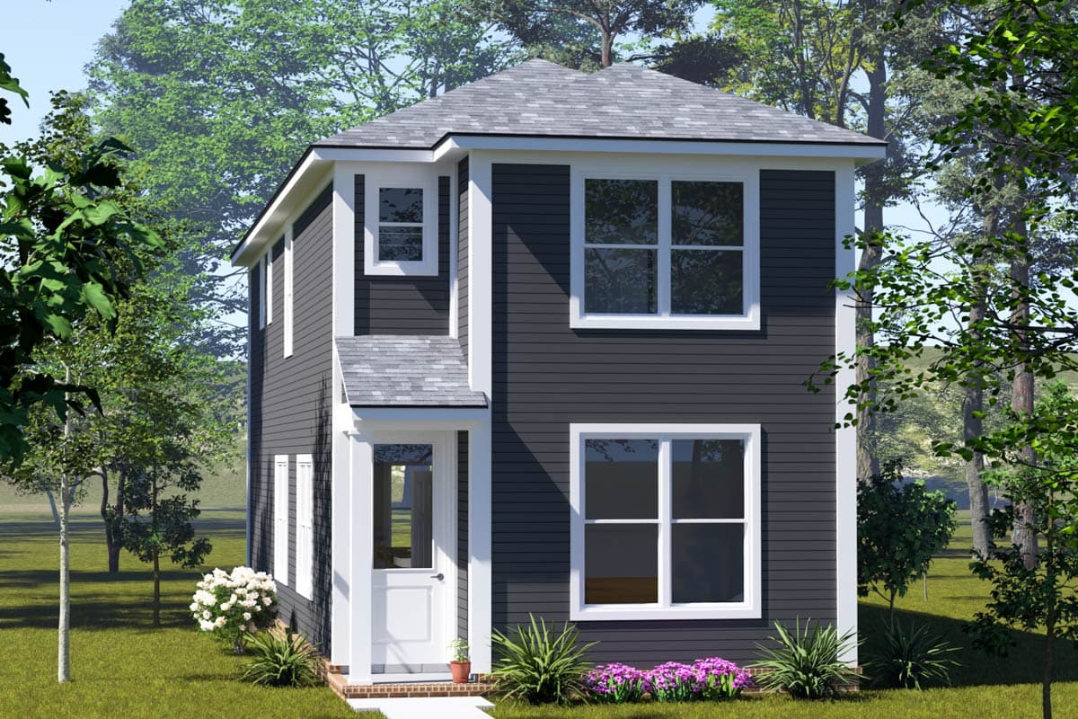 A two-story house with dark gray siding and white trim. It has a gabled roof and a small front porch, surrounded by trees and landscaping.