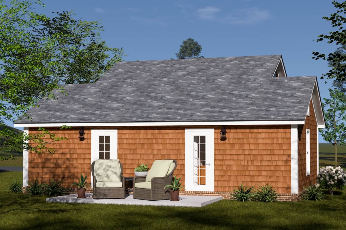 House plan exterior featuring cedar shake siding, a gable roof, and two french doors opening to a patio.