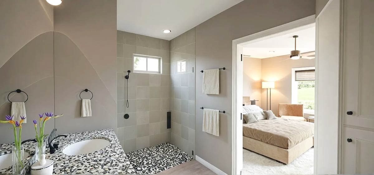 Modern bathroom featuring a shower with a pebble floor, a vanity with a patterned countertop, and a glimpse into an adjacent bedroom.