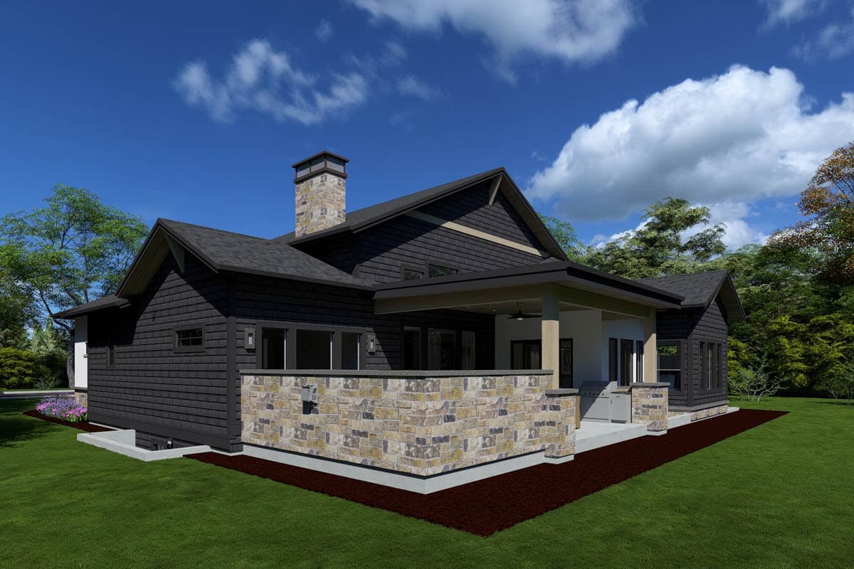 Modern house plan exterior with dark siding, stone accents, covered patio with outdoor kitchen, and stone chimney.
