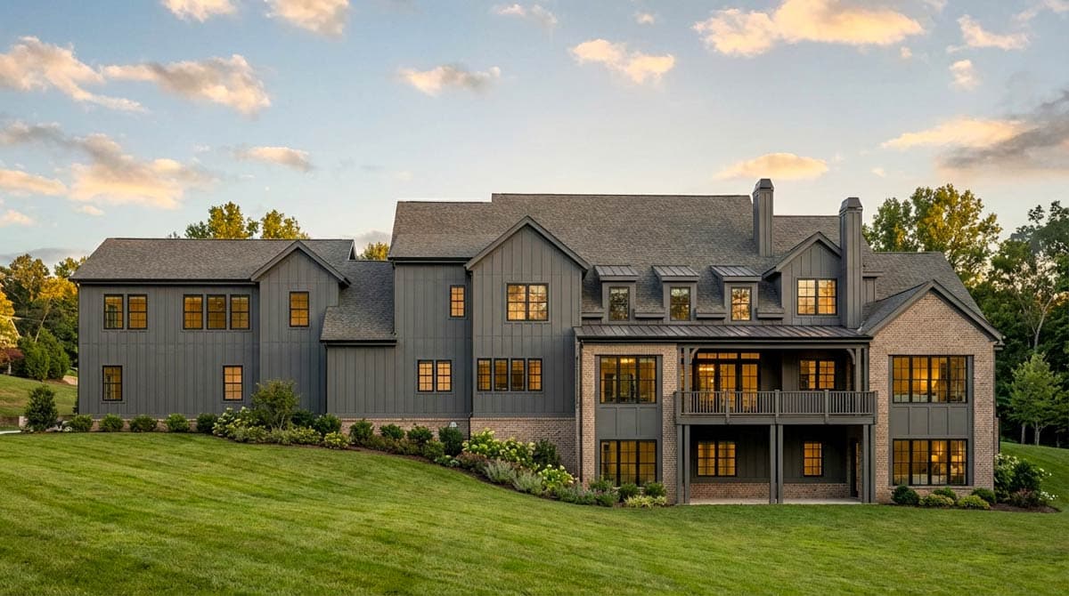 Modern Farmhouse house plan exterior with board and batten siding, brick base, multiple gables, dormers, and a wraparound deck.