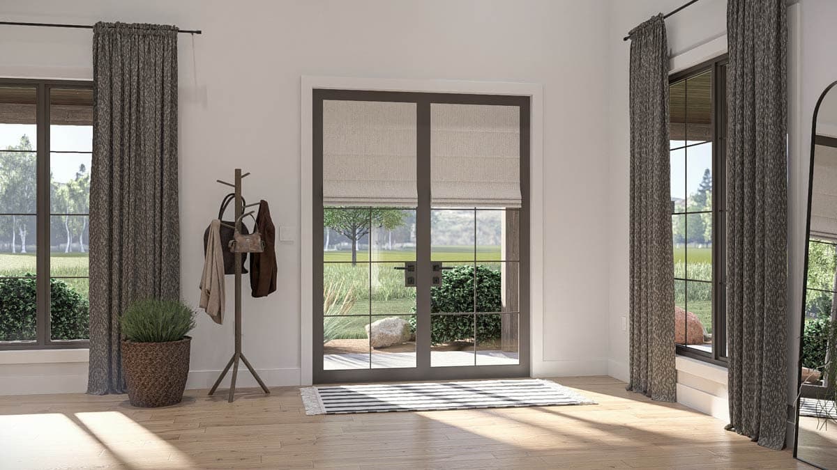 Interior view of a room with large windows, French doors, and a coat rack with bags and jackets.