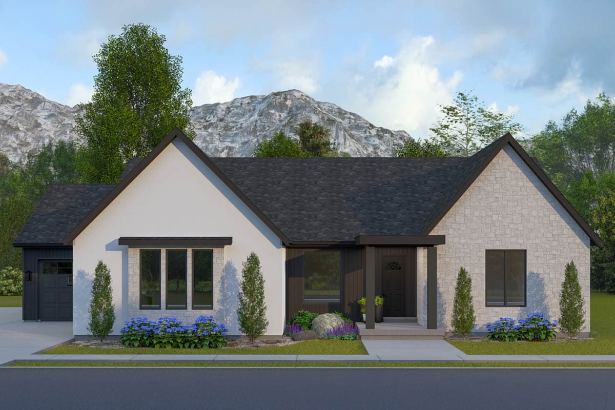 A modern, single-story house with a white exterior, dark trim, and a gray stone accent wall. Mountains and trees form the backdrop.