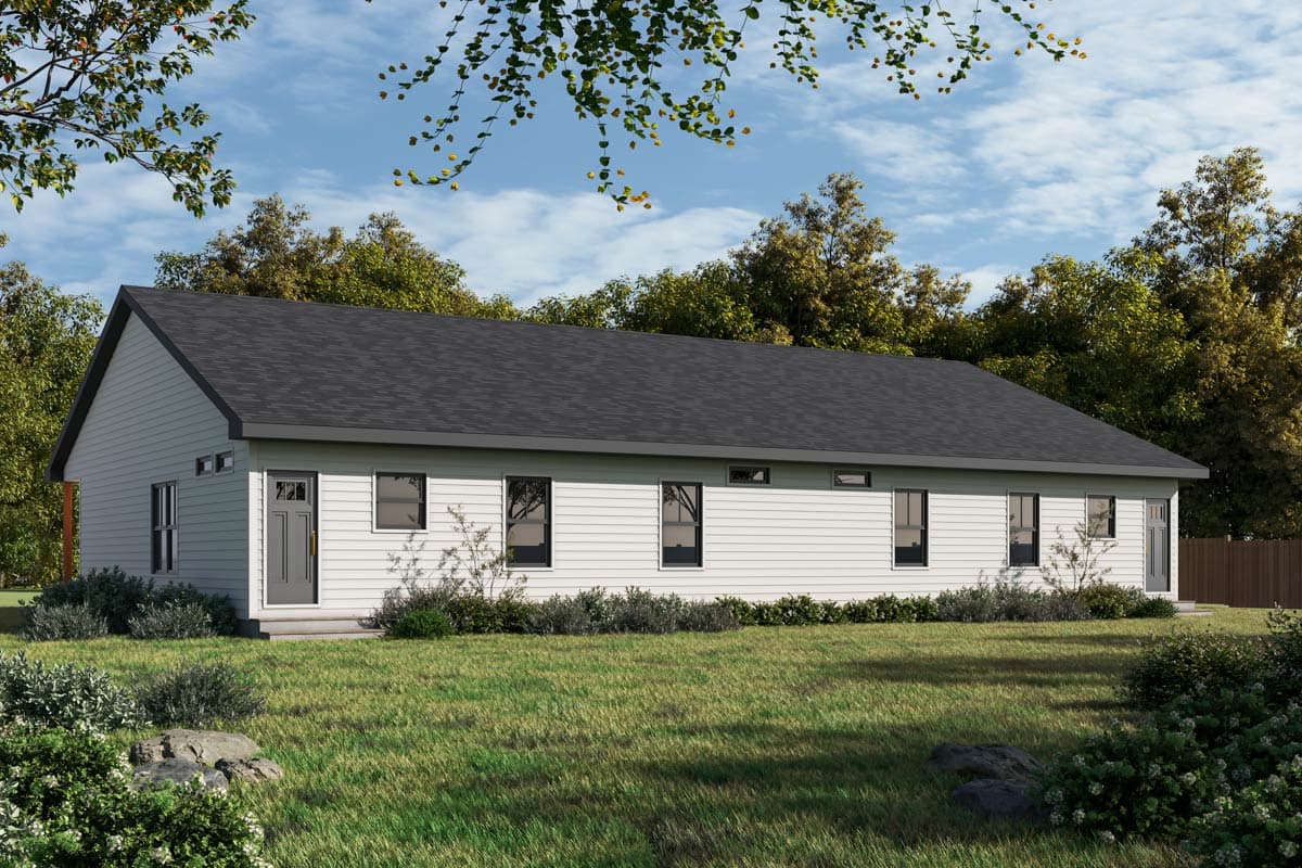 A modern, white-sided house with a dark gray roof sits on a grassy lawn. The house has several windows, surrounded by trees and a blue sky.