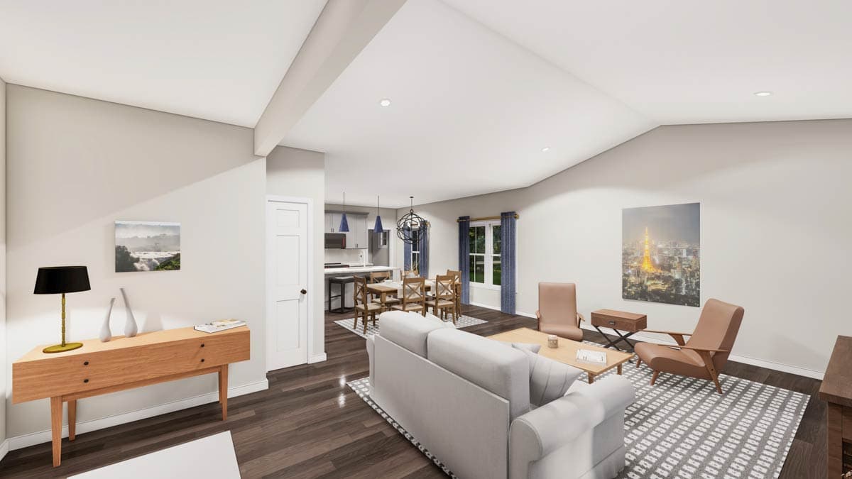 Living room and kitchen with vaulted ceiling, island, dining table, and sofa.