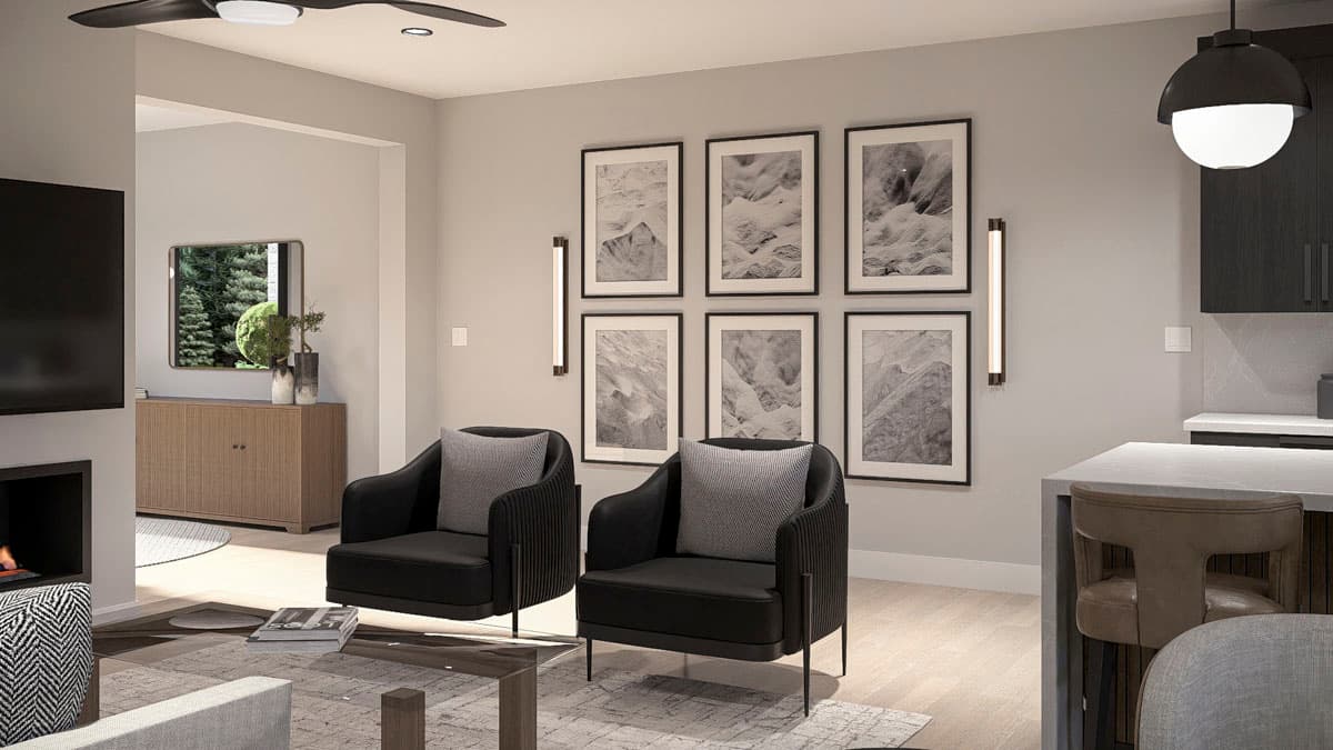 Living area with fireplace and two black accent chairs, wall art, and view of entryway with cabinet.