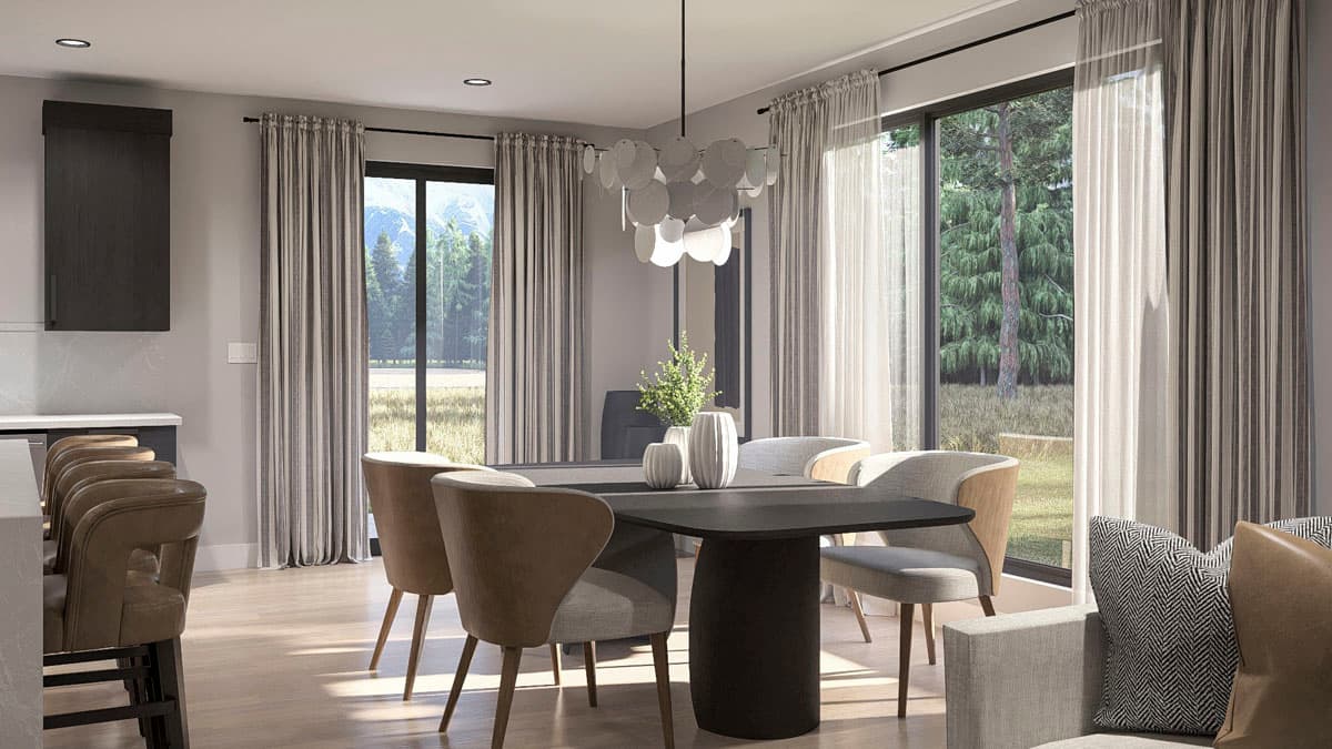 Dining area with contemporary table, chairs, and chandelier; large windows overlook a wooded landscape.