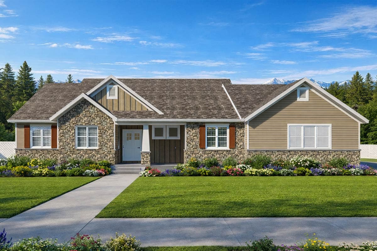 A craftsman-style house with stone and tan siding, a manicured lawn, and colorful flower beds. Mountains and a blue sky are visible in the background.