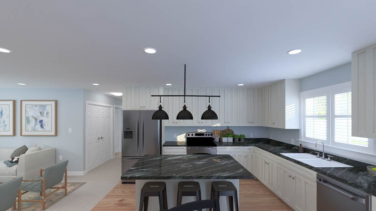 Kitchen with island, stainless steel appliances, white cabinets, dark granite countertops, and pendant lighting.