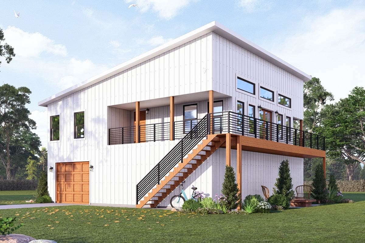 A modern two-story home with a white exterior, wooden accents, and a staircase leading up to a balcony. A bicycle sits nearby on the lawn.