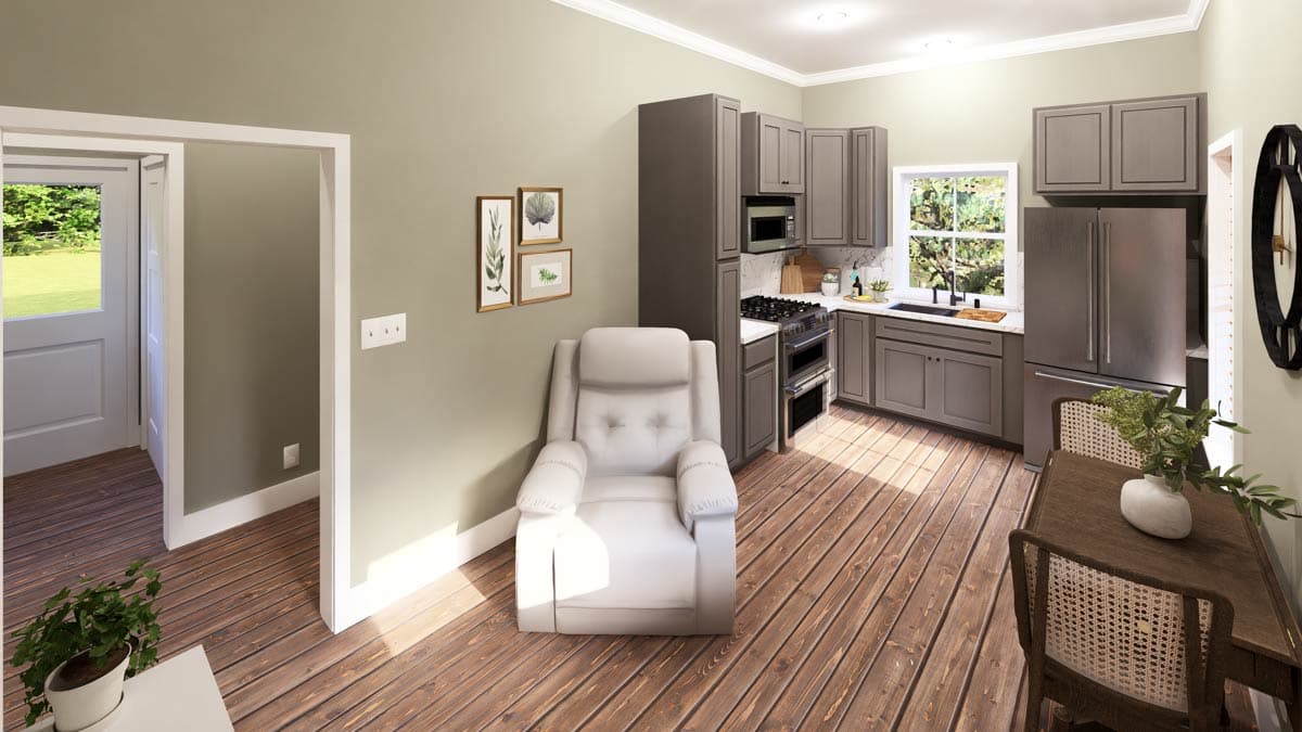 Interior view of kitchen and dining area featuring gray cabinets, a stainless steel refrigerator, a recliner, and a table with chairs.