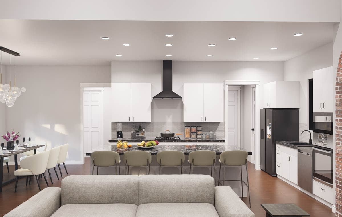 Open concept living area with a modern kitchen featuring a large island, white cabinetry, and stainless steel appliances.