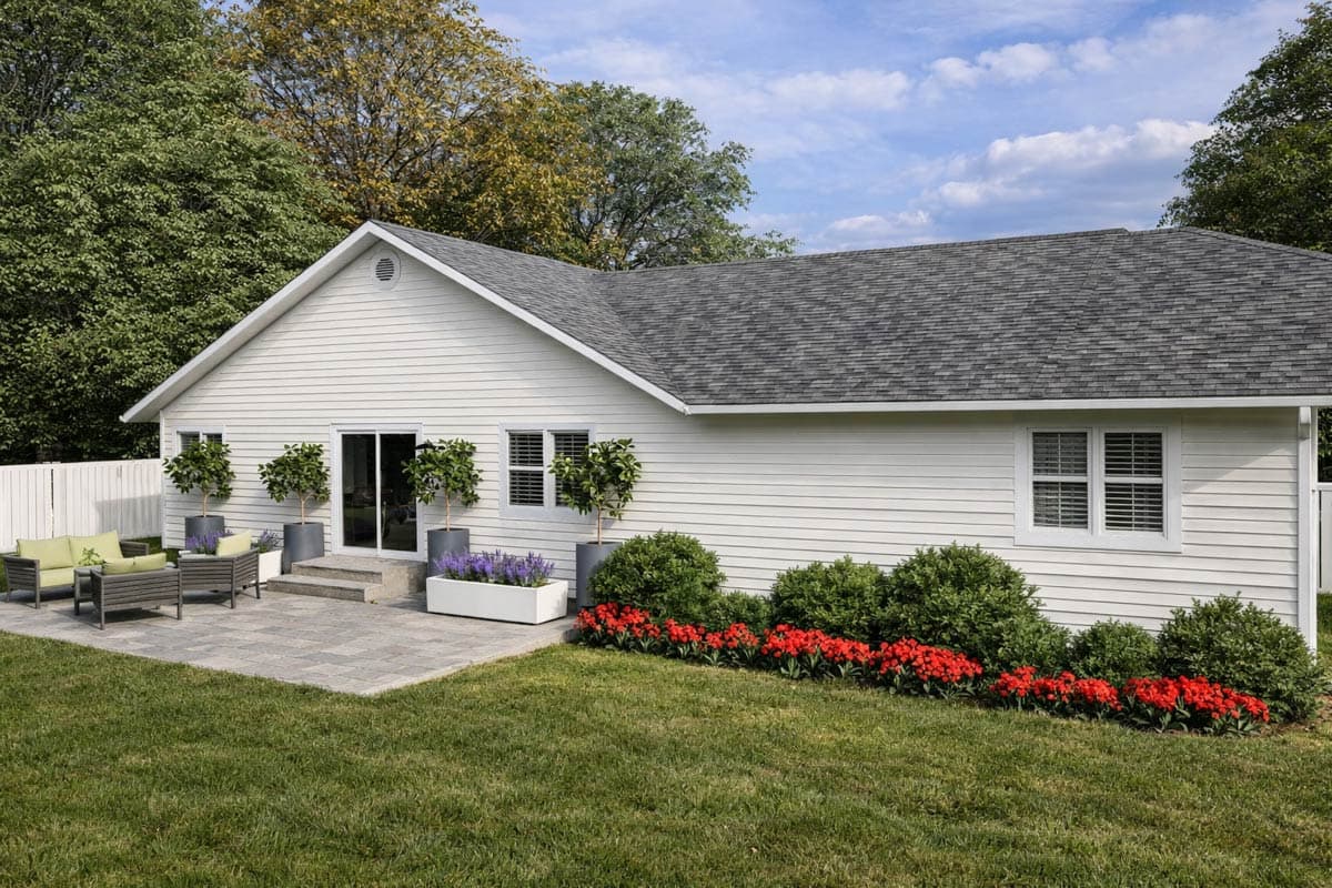 House plan exterior. One-story design with a gable roof, sliding door access to a patio, and horizontal siding. Features a well-manicured lawn.