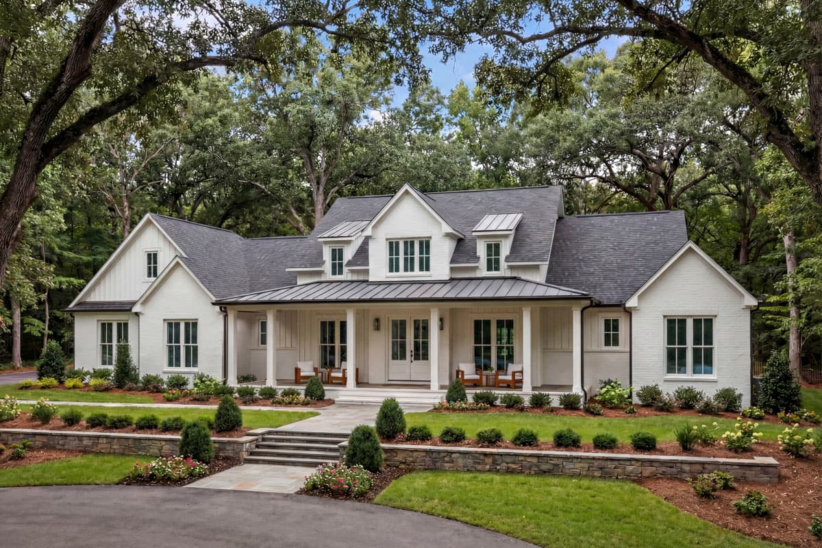 Modern Farmhouse house plan exterior with white brick, gables, dormers, and a covered porch with metal roof.