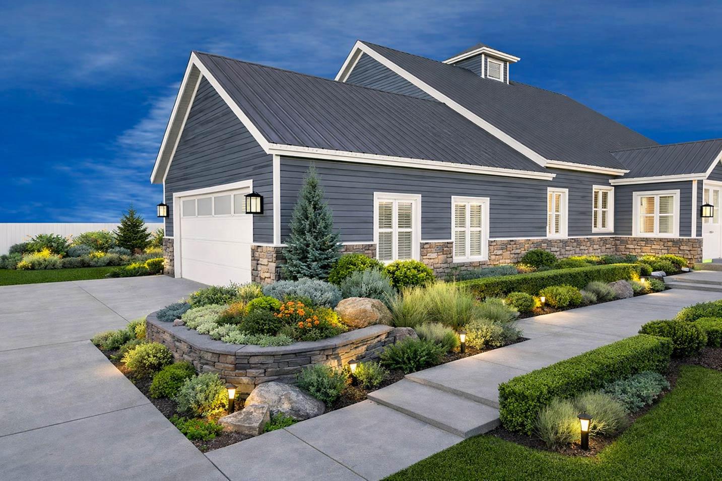 House plan exterior: Modern Farmhouse style, two stories, dark blue siding, stone base, metal roof, gables, dormer.