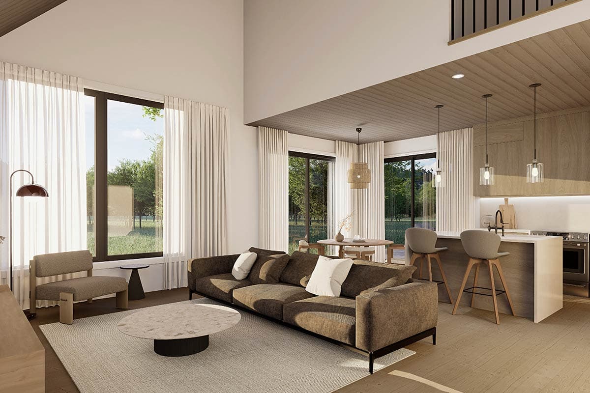 Modern open concept living space with vaulted wood-paneled ceiling, large windows, kitchen island with pendant lights, and dining area.