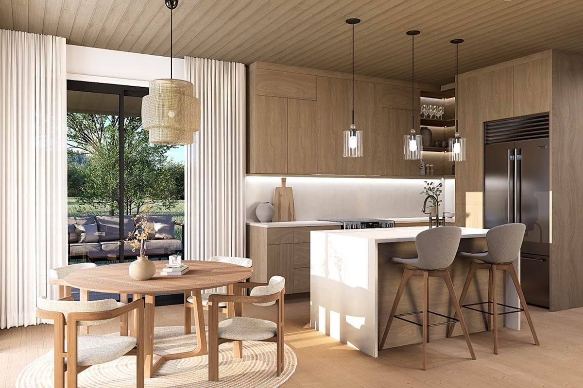 Interior rendering of a modern kitchen and dining area featuring wood cabinetry, a large island, and a round dining table.