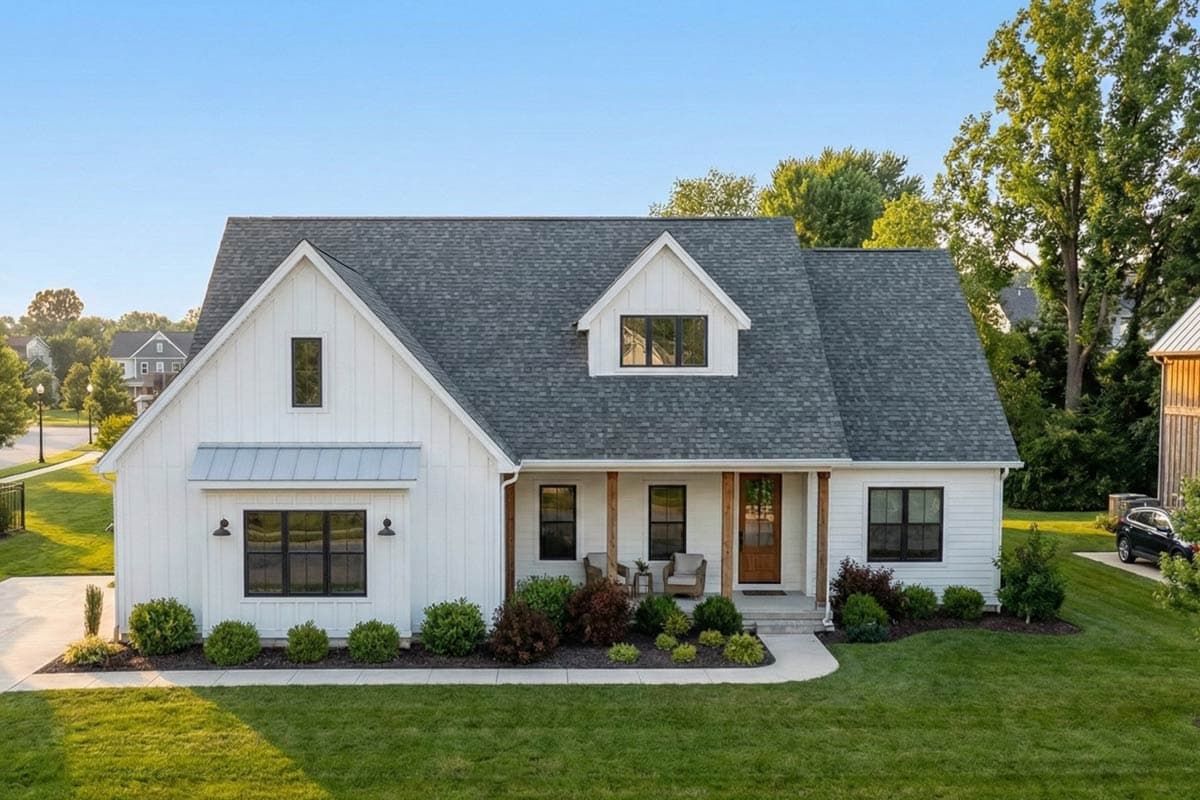 House plan exterior. Two-story Modern Farmhouse with gables, a covered porch with wooden supports, and dormer windows.