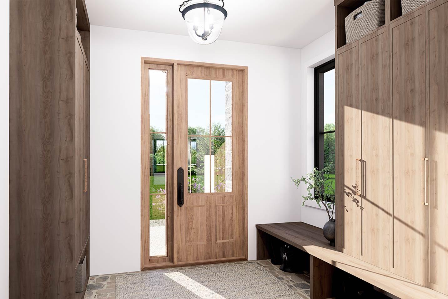 Mudroom entry with double wooden doors with glass panes, wooden built-in cabinets, bench, and stone tile floor.