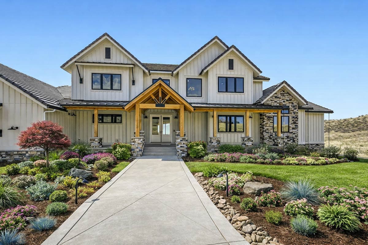 House plan exterior showcasing modern farmhouse style with prominent gables, board-and-batten siding, and timber-framed entrance.