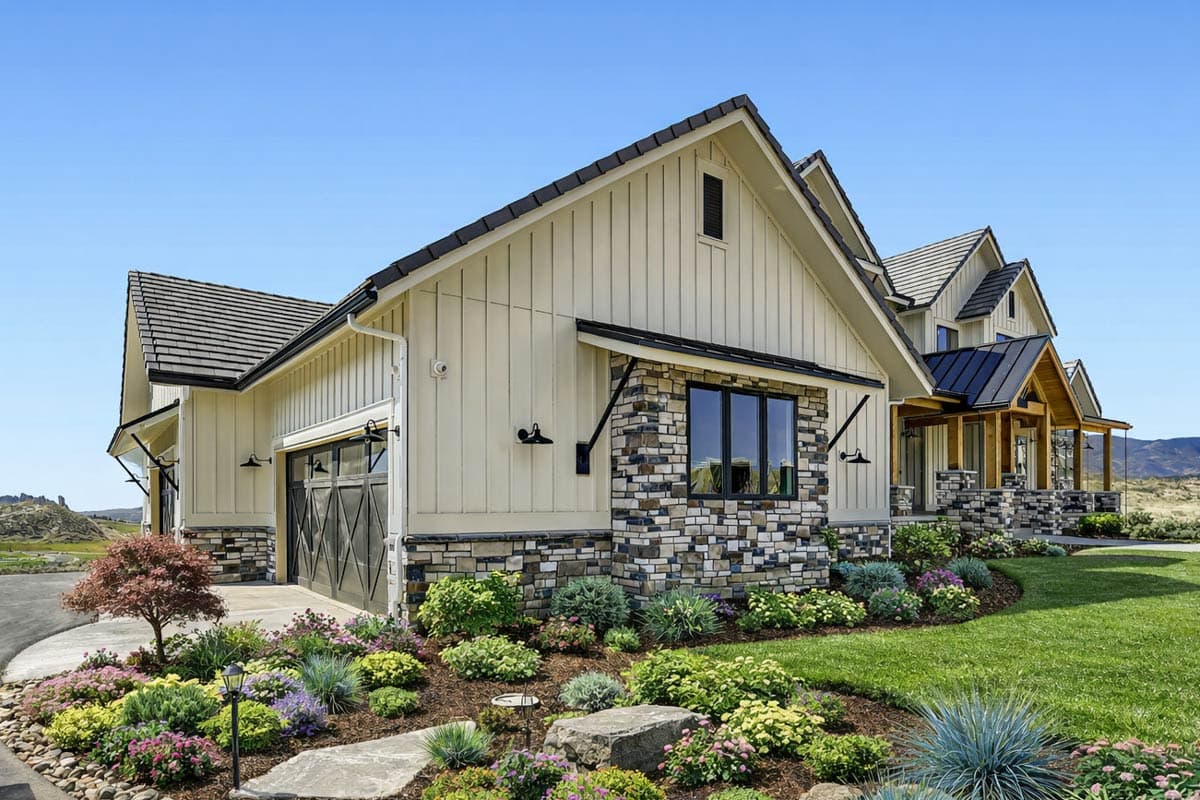 House plan exterior featuring board-and-batten siding, stone accents, gable rooflines, and a two-car garage.