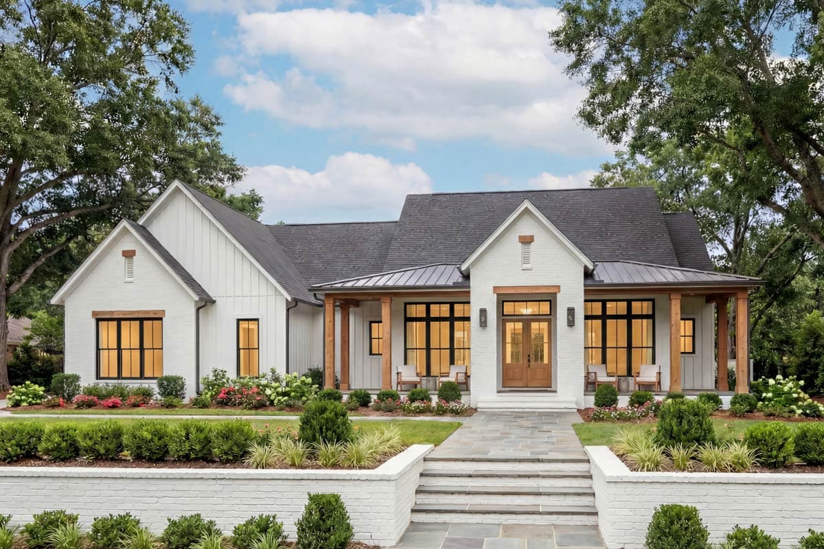 House plan exterior. Modern Farmhouse style with two stories, gabled rooflines, a covered porch, and a brick pathway leading to the front door.