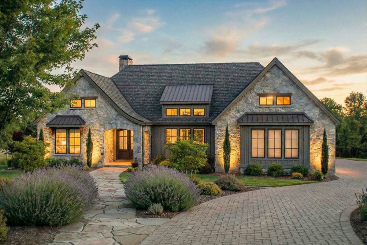 House plan exterior: Stone-clad, two-story home with gables, dormers, a covered entryway, and varied rooflines.