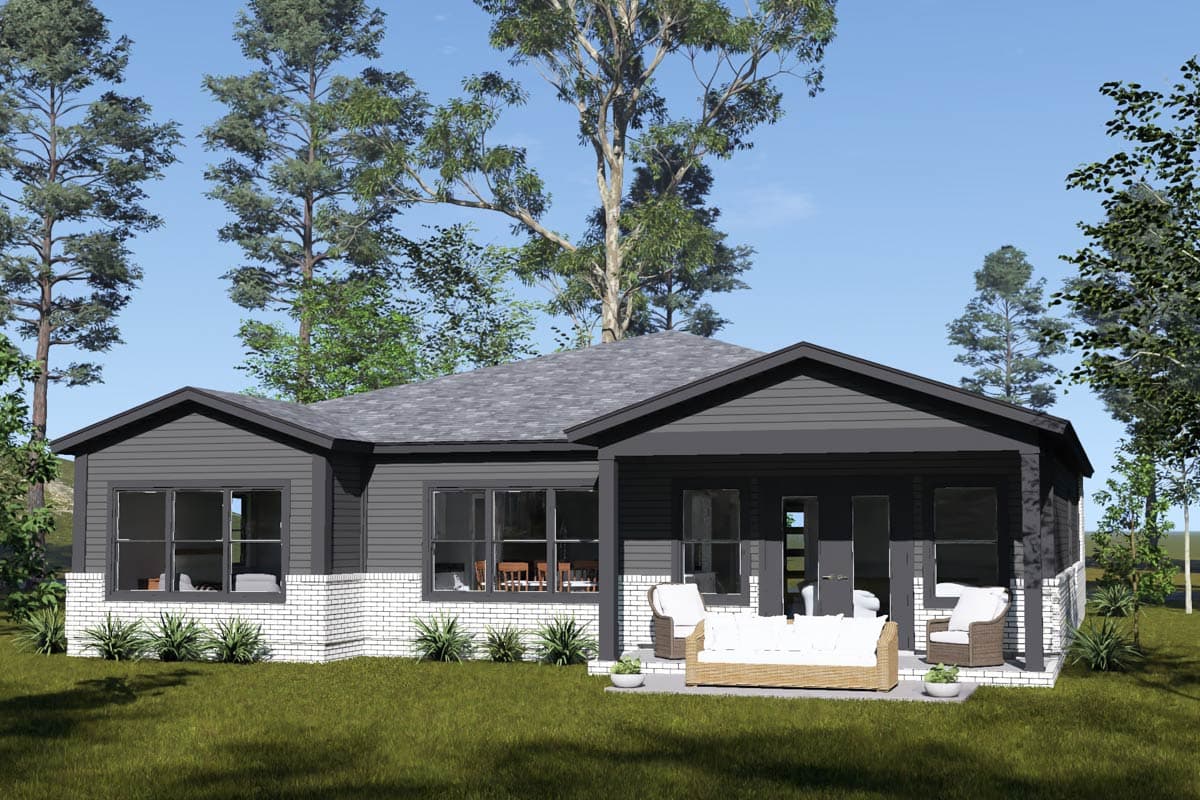 House plan exterior: One-story home with dark siding, white brick base, gabled rooflines, and covered patio with seating.