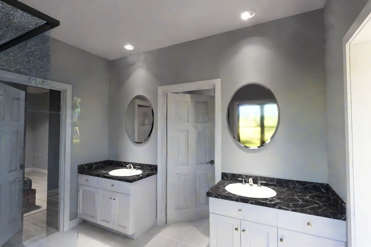 Bathroom with double vanity, white cabinets, dark marble countertops, two circular mirrors, and an open doorway to a closet.